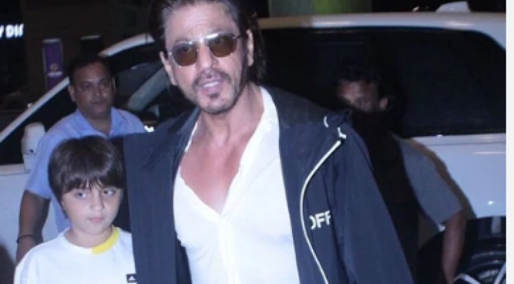 As they walk to the airport, Shah Rukh Khan holds his son AbRam's hand.