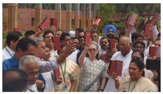 "India bloc leaders protest outside Parliament with Constitution."