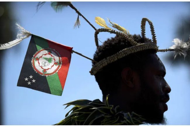 At least 26 villagers are killed by a gang in Papua New Guinea.